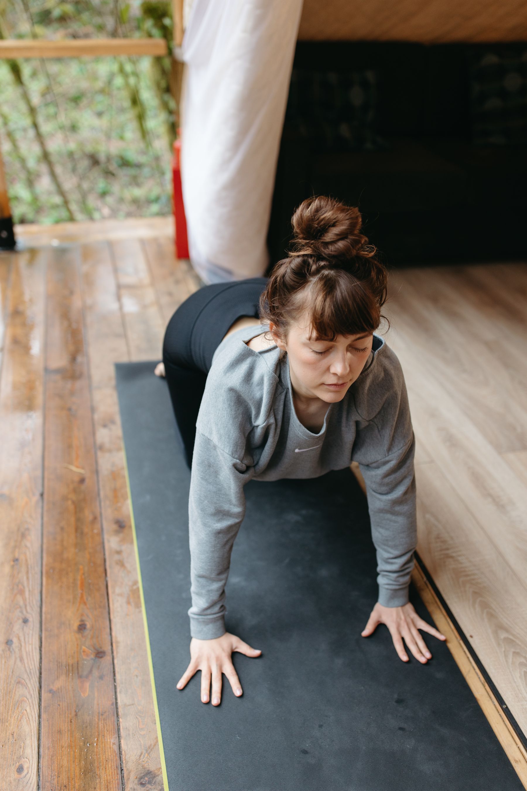 Woman in activewear doing a plank on a yoga mat