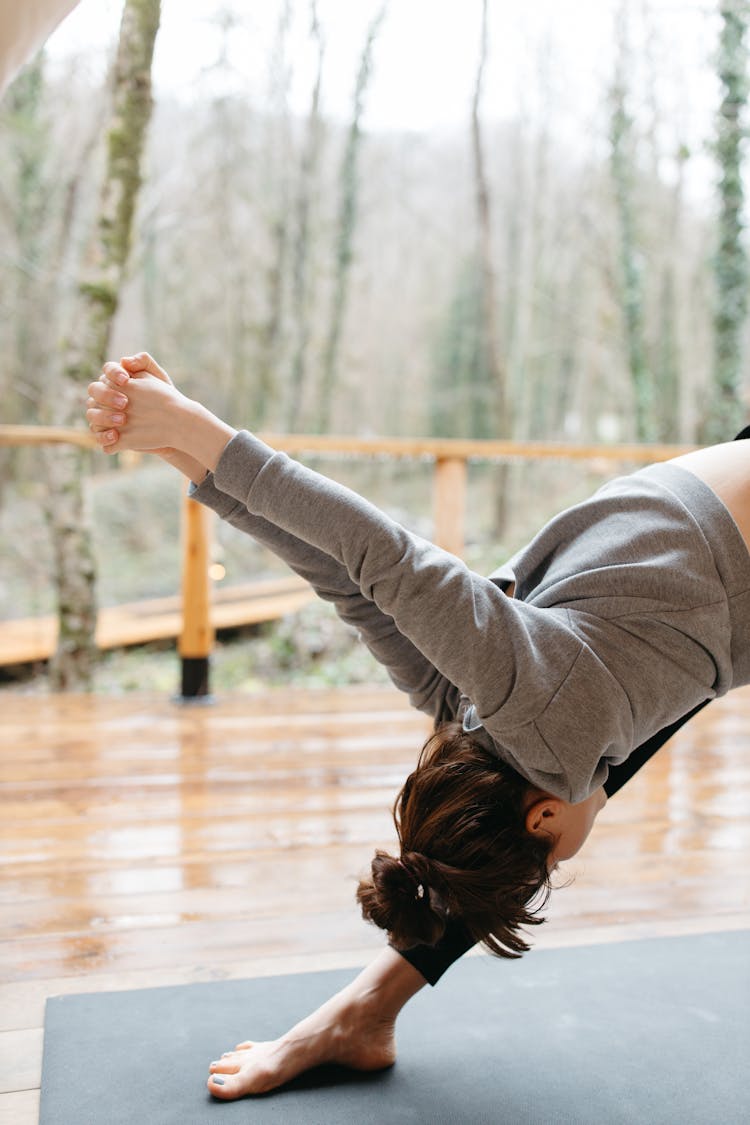 Woman Wearing Gray Sweater Doing Exercise