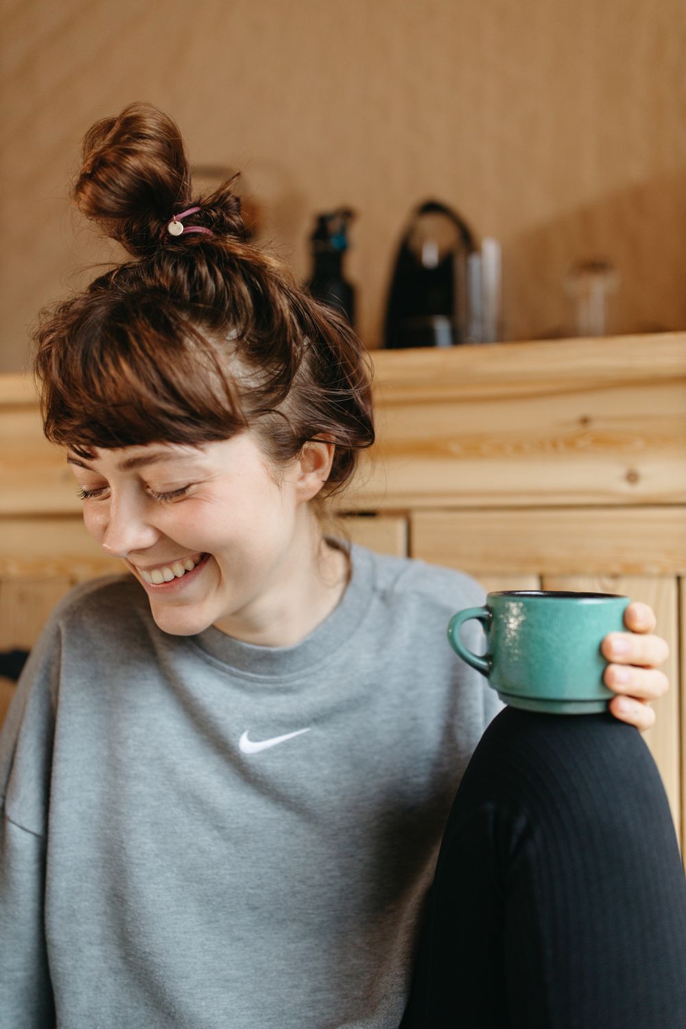 Woman in Gray Sweater Holding a Cup of Coffee · Free Stock Photo