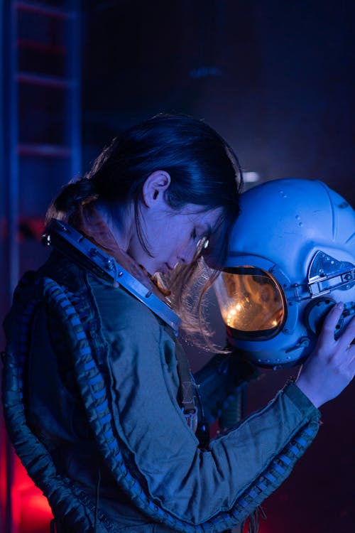 Woman in Blue Spacesuit Feeling Tired