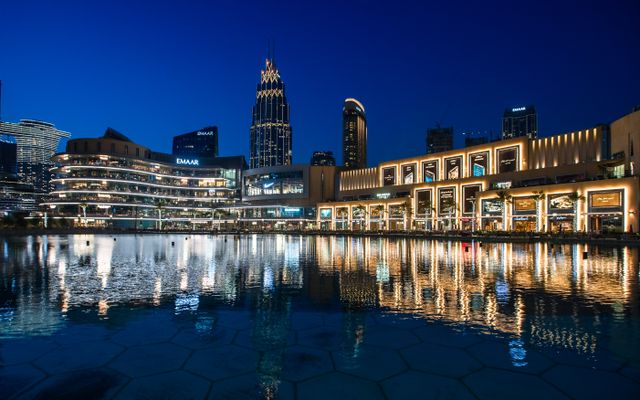 Photo: Denys Gromov on Pexels Stunning view of illuminated skyscrapers reflecting on water at Dubai Mall waterfront.