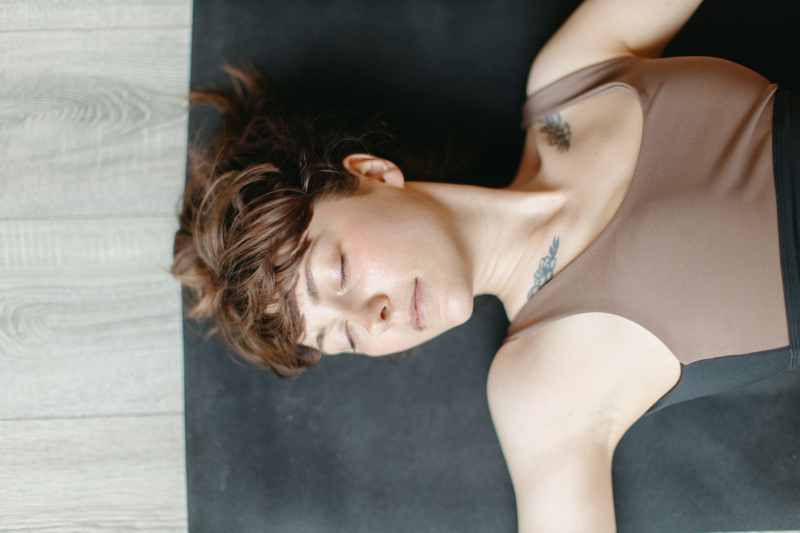 Person in restorative child's pose on a yoga mat, a gentle pose often recommended for anaemia-related fatigue