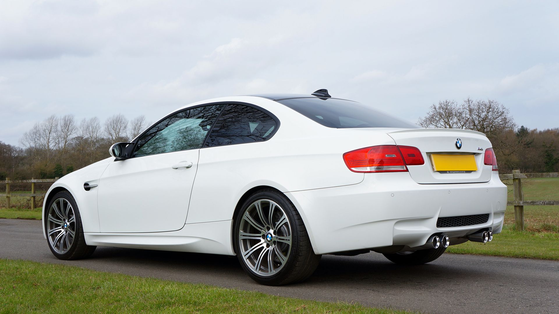 Elegant BMW M3 coupe in a picturesque rural setting in the UK. Ideal for auto enthusiasts.