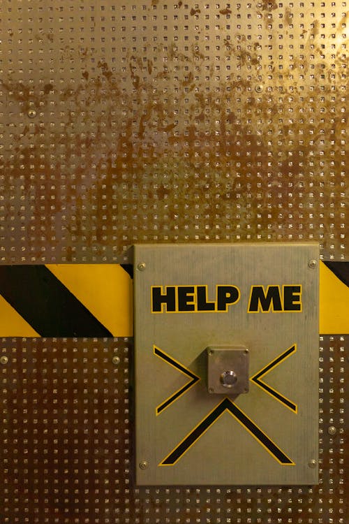 Free Help Me Sign With Button On Wall Stock Photo