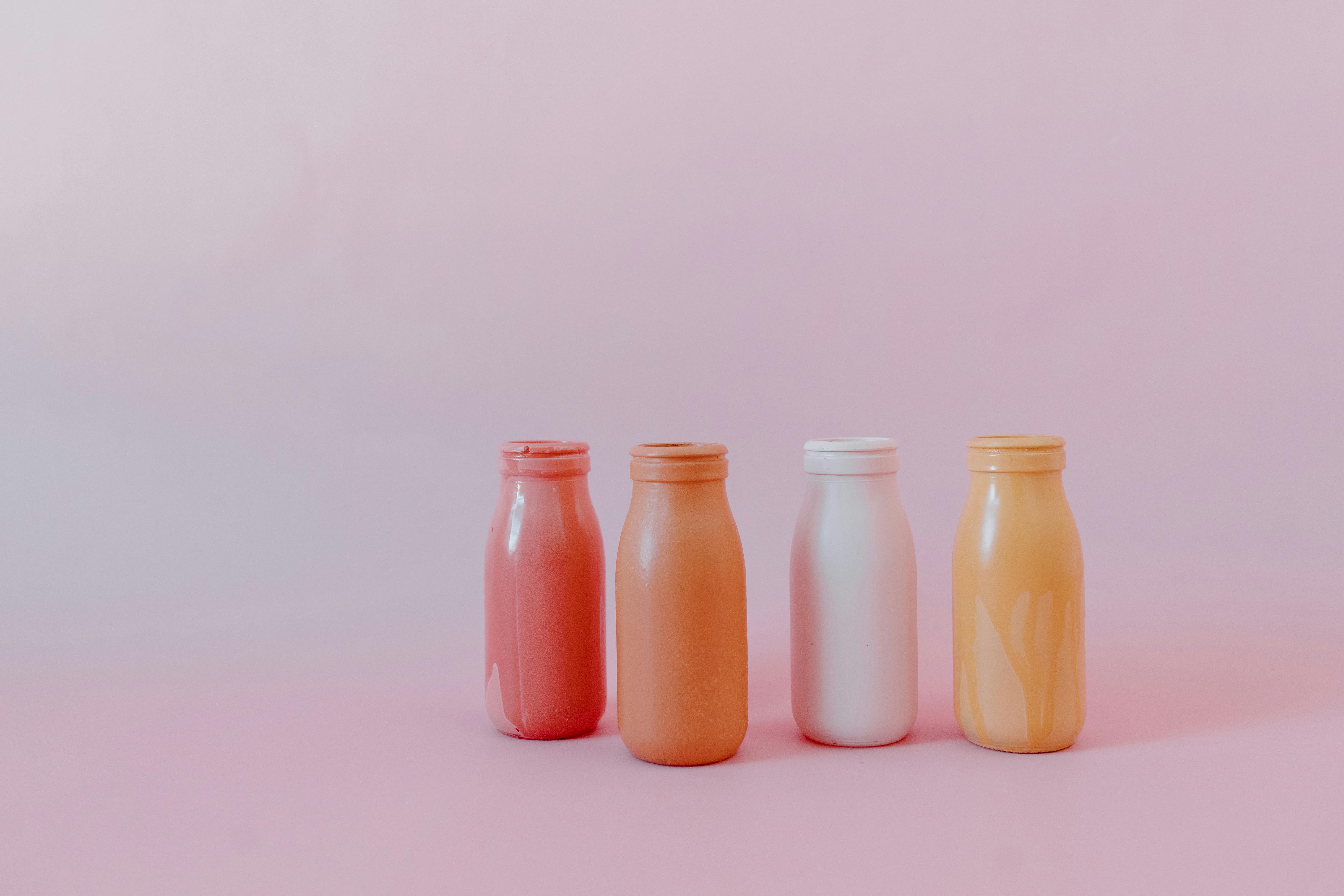 2 orange bottles on white surface