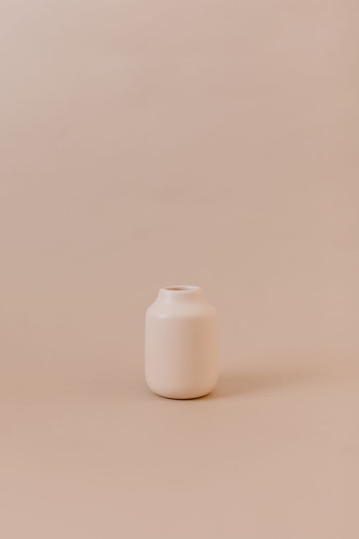 Beige ceramic pot against a matching wall, by Tara Winstead on Pexels