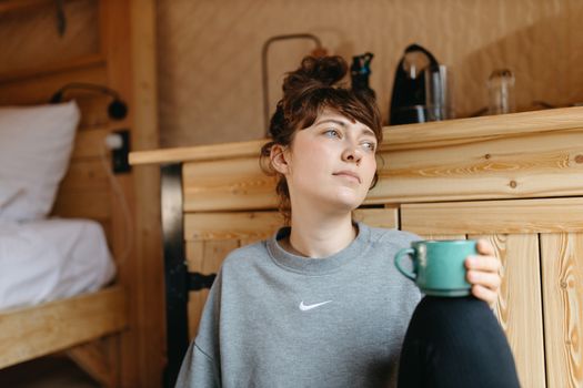 Woman in Gray Crew Neck Shirt Holding Blue Ceramic Cup