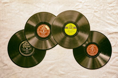 Photo of Vinyl Records on a White Textile