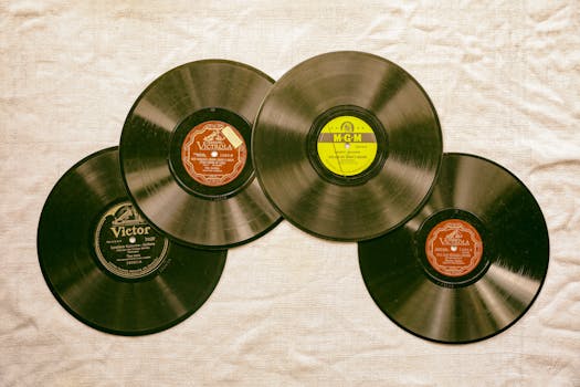 A collection of classic vintage vinyl records displayed on a textured background, evoking nostalgia and musical history.