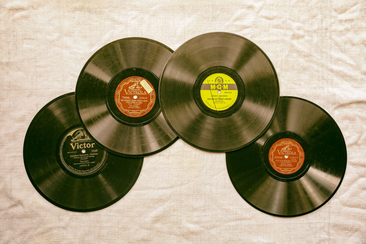 a collection of classic vintage vinyl records displayed on a textured