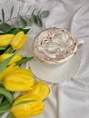 White Ceramic Cup With Saucer Beside Yellow Tulips