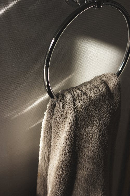 Towel hanging on ring in sunbeam in bathroom