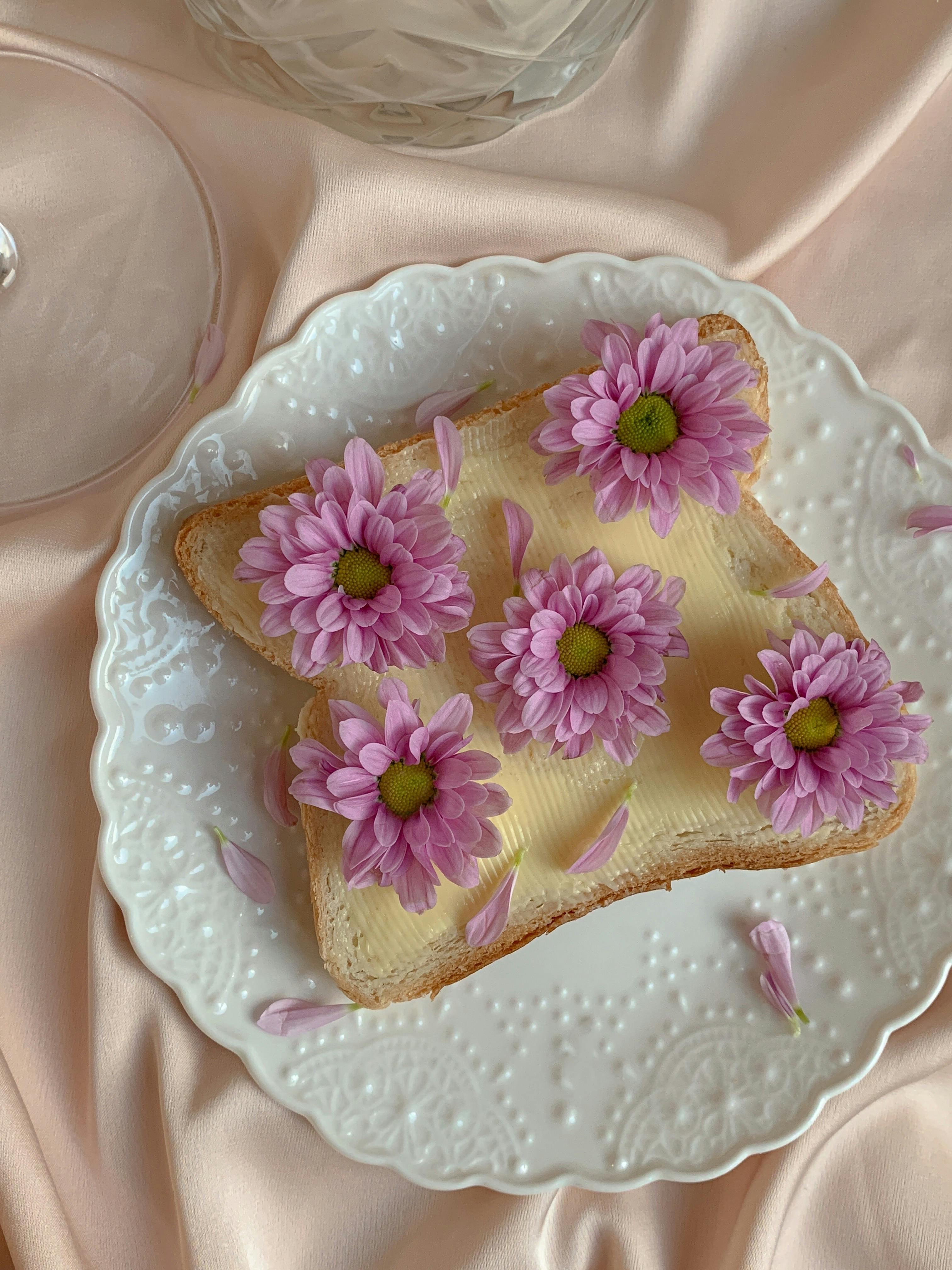 toast decorated with pink flowers on a ceramic plate