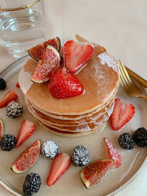 Free Close-Up Photo of Mouth-Watering Stack of Pancakes with Fresh Berries on a Plate Stock Photo