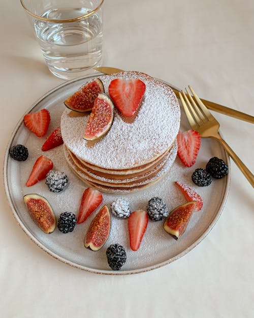 Free Close-Up Photo of Mouth-Watering Stack of Pancakes with Fresh Berries on a Plate Stock Photo