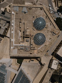 Drone shot capturing the unique geometric architecture in Valletta, Malta with two dome structures.