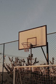 Basketball hoop under clear sky in Recanto dos Eduardos, showcasing outdoor sports culture.