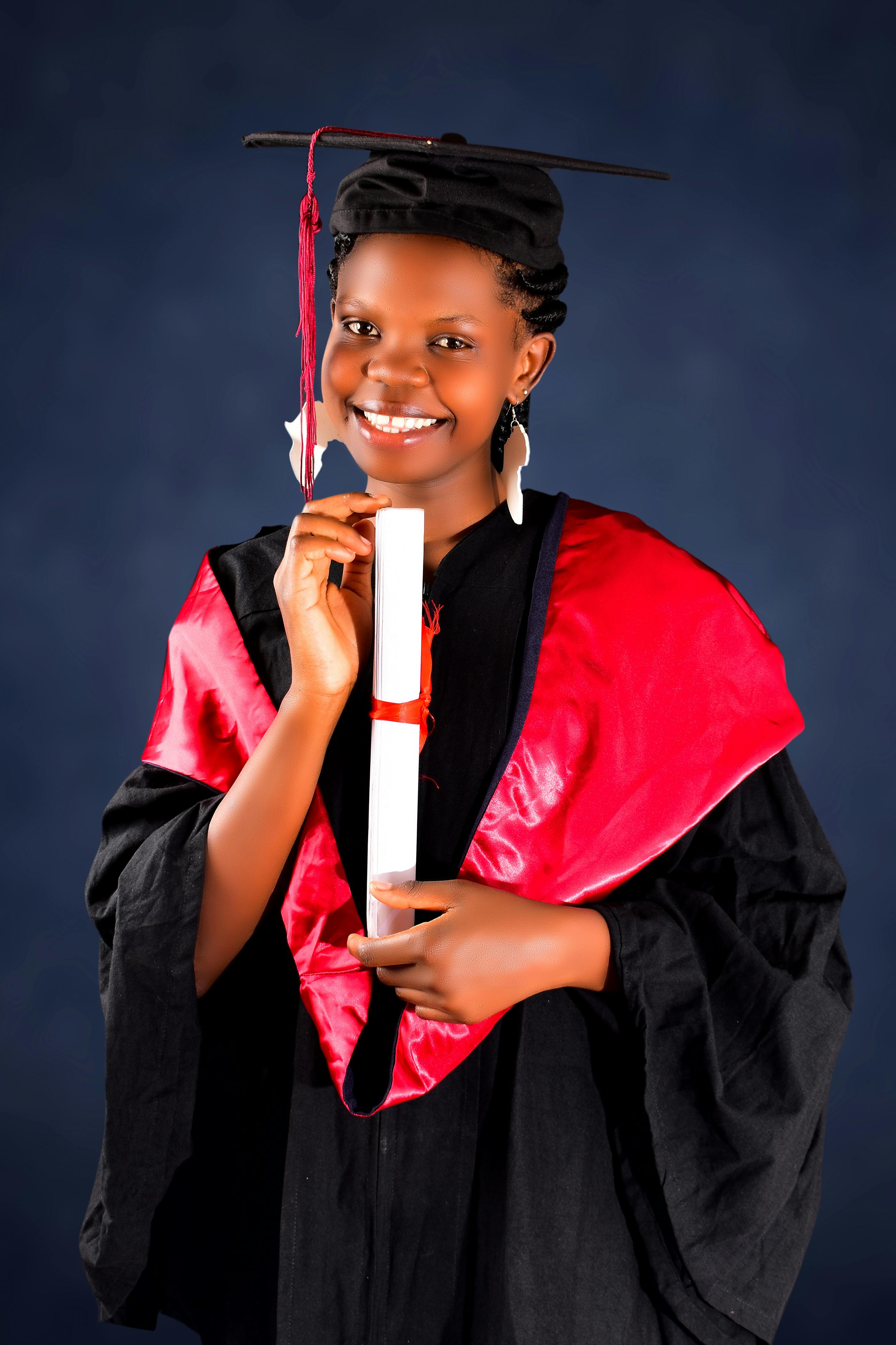 African american female graduate wearing graduation cap and ceremony robe  holding Certificate tied with red ribbon. Proud dark skin high school  studen Stock Photo - Alamy