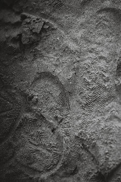 Monochrome Photo of Footprints on the Sand