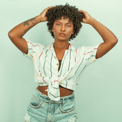 Woman with Short and Curly Hair Looking at Camera while Posing