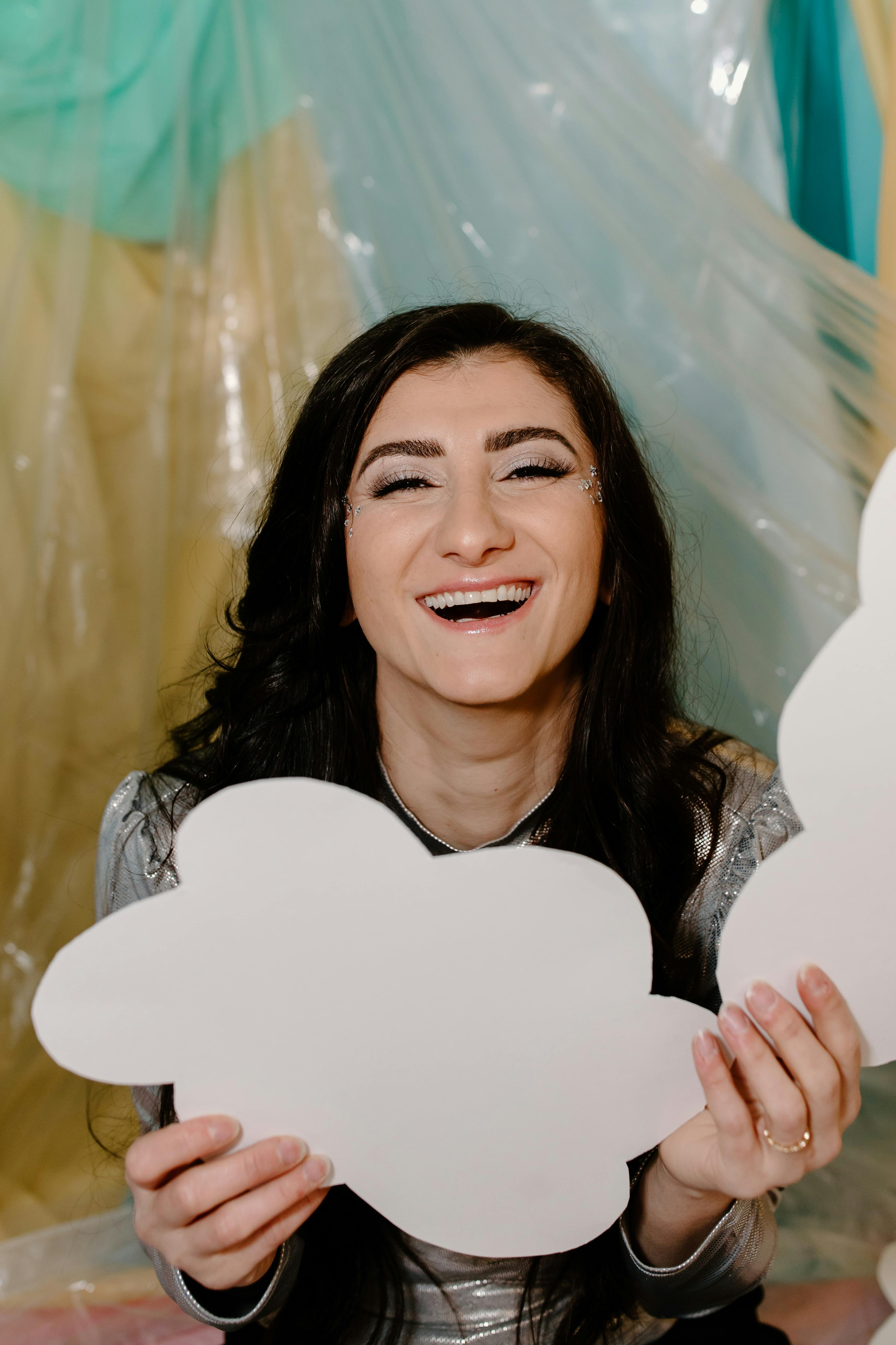 smiling woman holding white heart paper