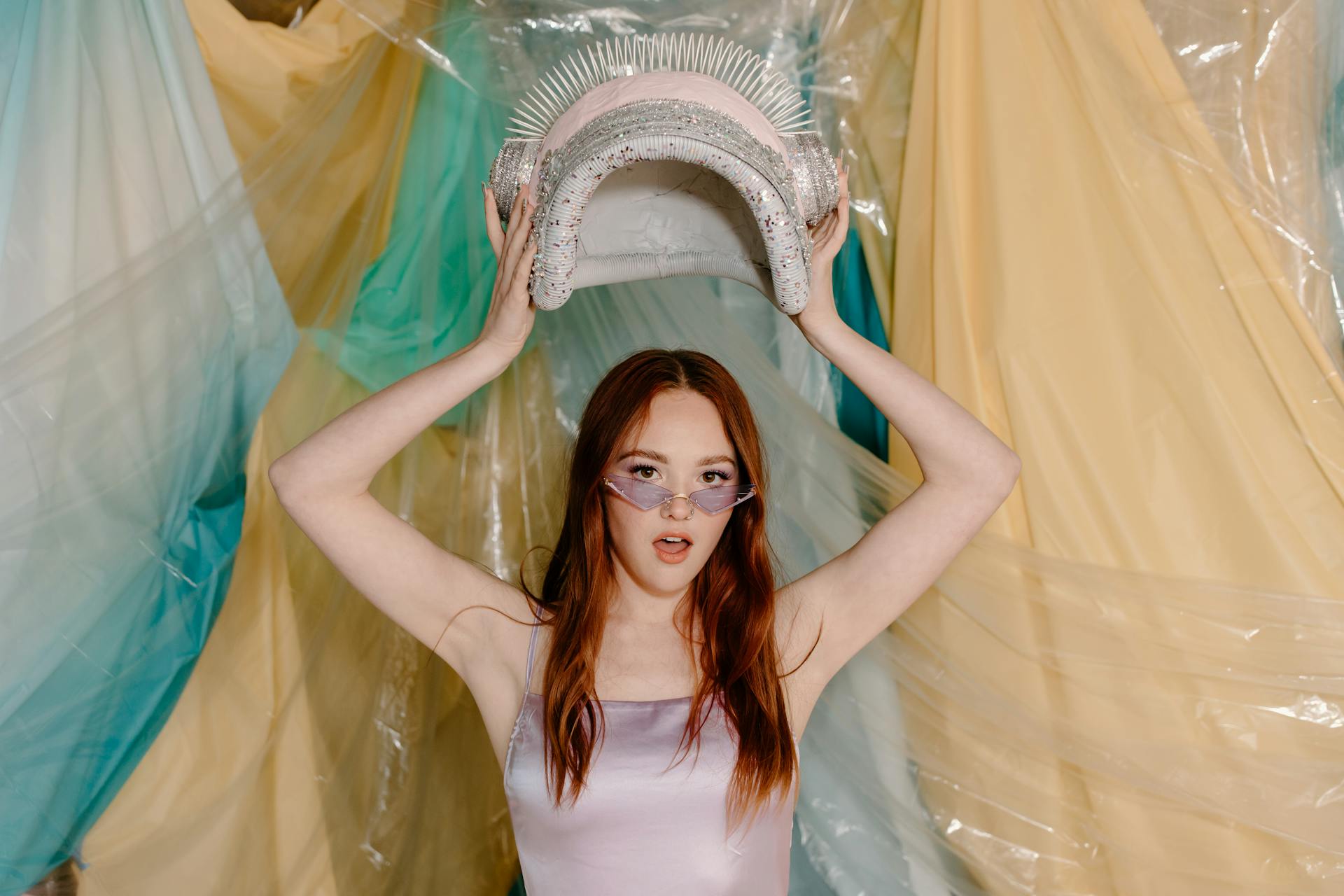 Woman in White Tank Top Holding White and Green Curtain