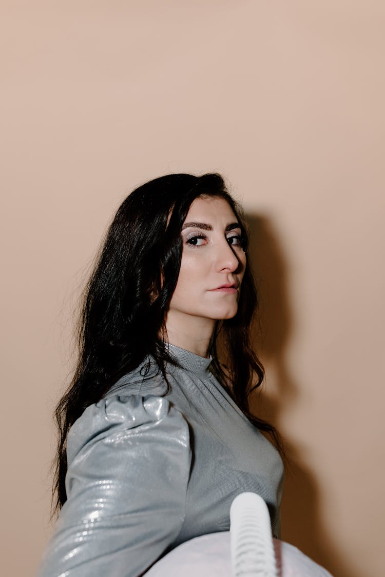 Woman In Gray Top With A Shadow On Wall 