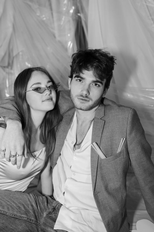 Free A fashionable young couple poses in a stylish monochrome portrait, exuding modern elegance. Stock Photo