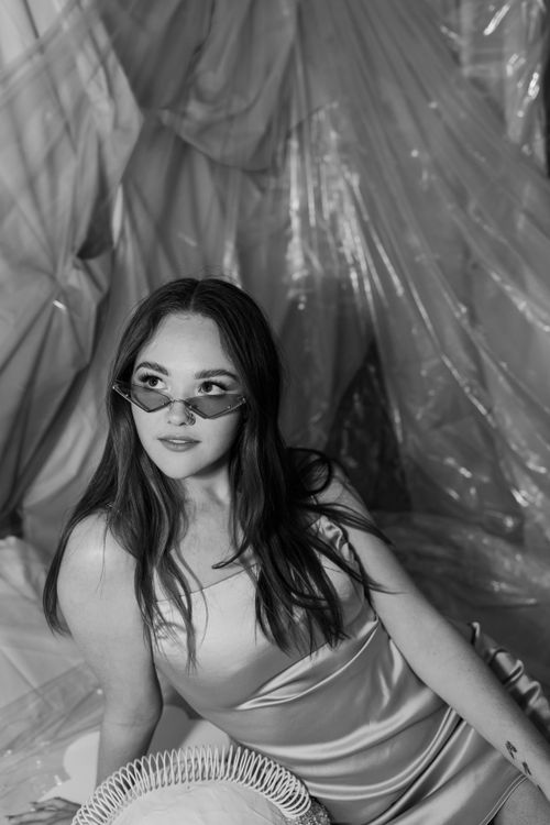 Free Stylish black and white portrait of a woman wearing sunglasses in a studio setting. Stock Photo