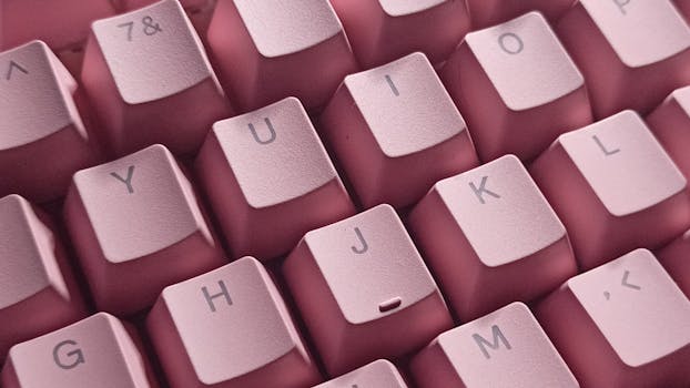 A detailed close-up of pink keyboard keys, ideal for tech backgrounds.