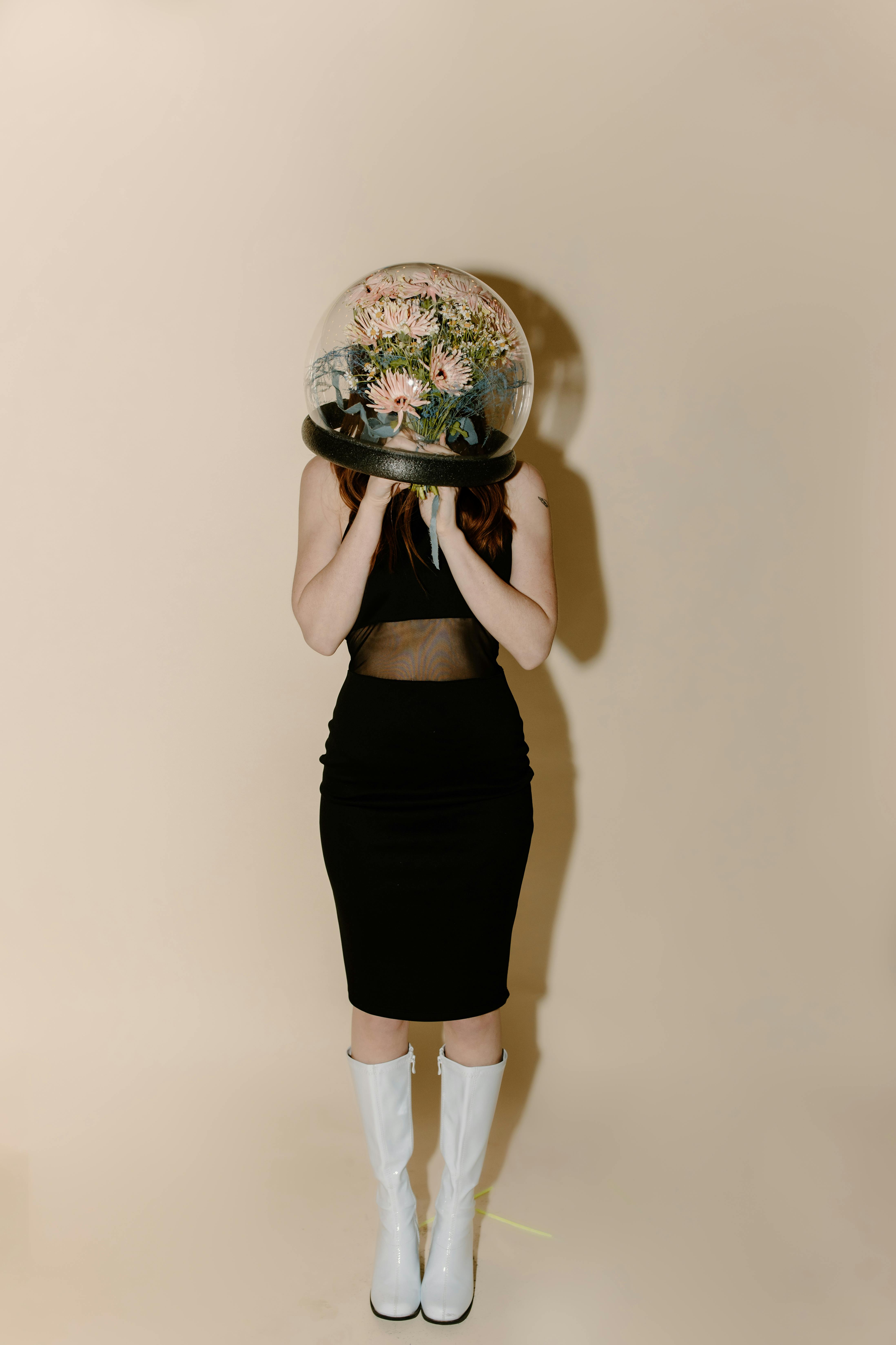 woman in black skirt holding round mirror