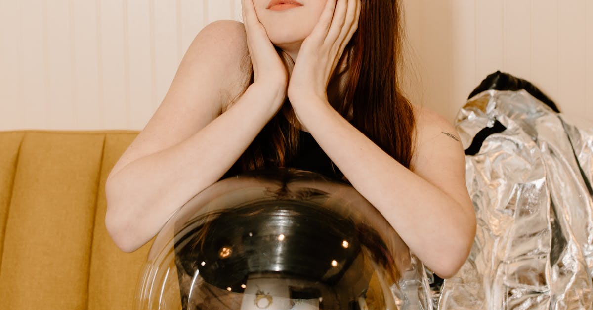 Woman in Black Tank Top Sitting on Brown Couch