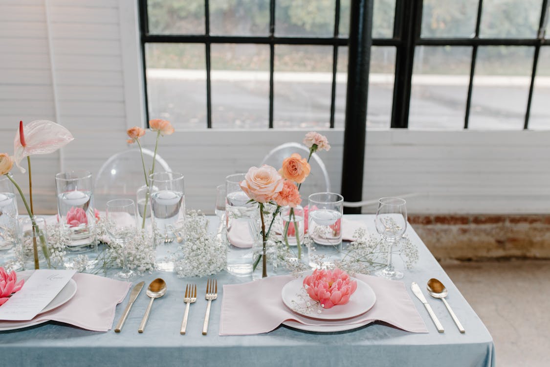 White and Red Roses on Clear Glass Vase on Table