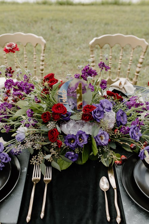 Purple and White Flowers on Black Ceramic Vase