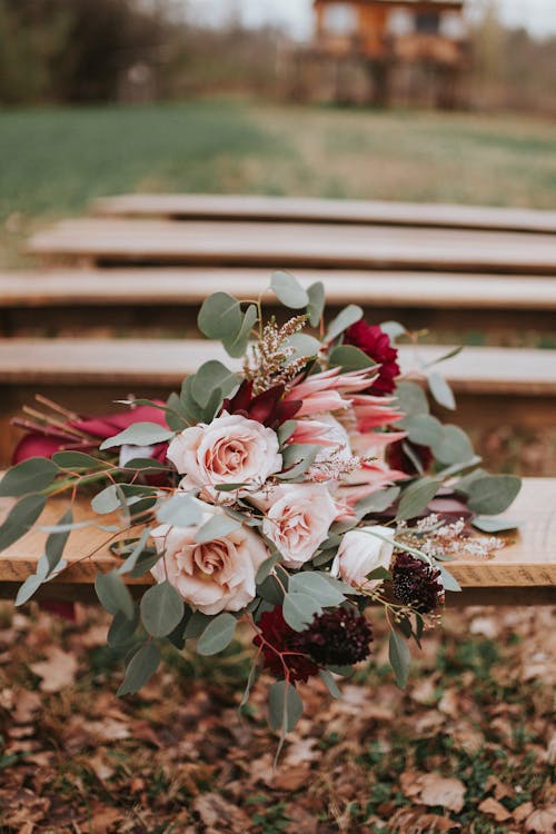 White and Pink Roses Bouquet on Brown Wooden Bench