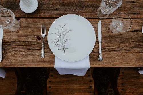 Free Elegant rustic table setting with vintage cutlery and floral dinnerware. Stock Photo