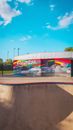 Skatepark with Waal Painting Under Blue Sky