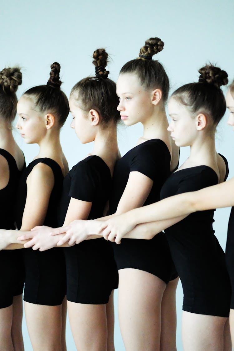 A Group Of Young Girls Standing Together