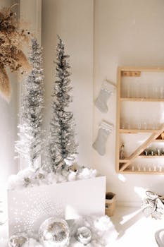 Stylish silver Christmas decorations with shimmering trees and stockings in a cozy indoor setting.
