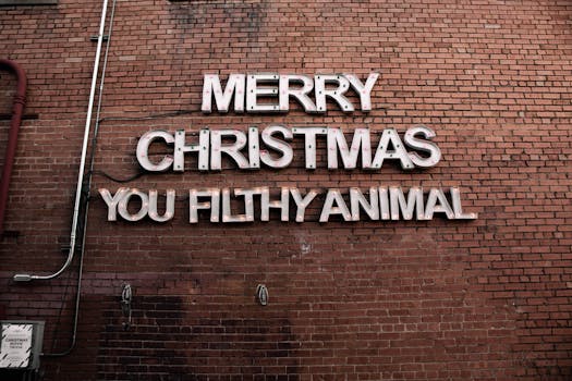 Brick wall with festive 'Merry Christmas You Filthy Animal' sign.