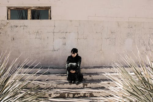 A Woman Sitting on the Stairs