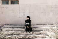 Woman in Black Jacket Sitting on Snow Covered Ground