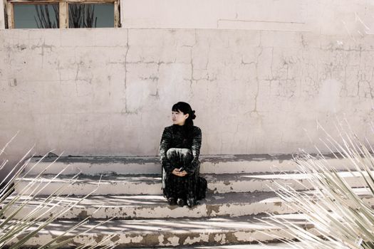 Woman in Black Jacket Sitting on Snow Covered Ground