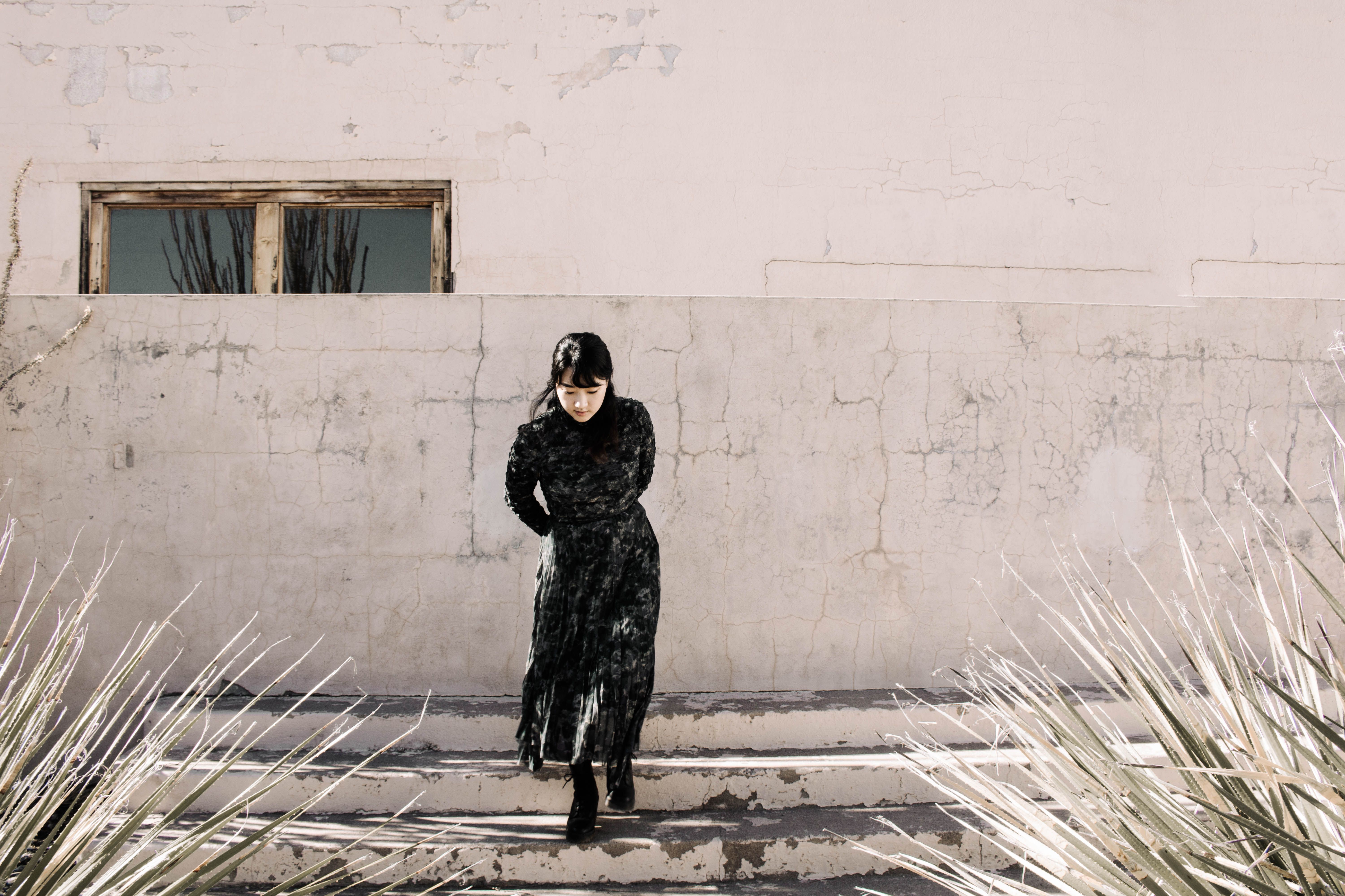 A Woman in Black Dress Walking Down on a Concrete Stairs · Free Stock Photo