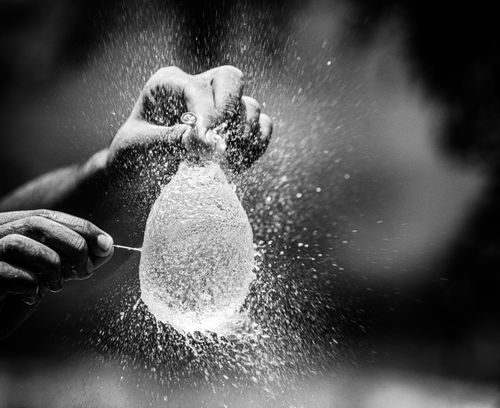 Free Captivating moment of a water balloon explosion captured in monochrome, showcasing motion and texture. Stock Photo