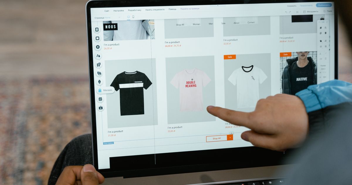 Person browsing a job board website on a laptop for sustainable fashion vacancies.