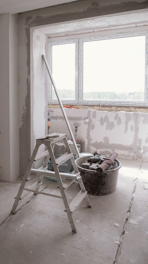 Free Sunlit room under renovation with tools and ladder, embodying modern DIY projects Stock Photo