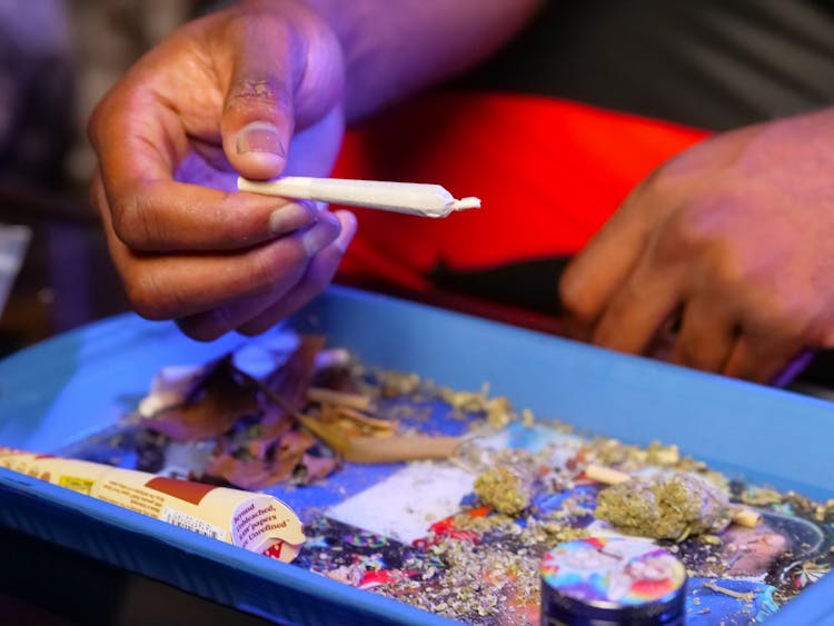 Close-Up Photo Of Person Holding Blunt