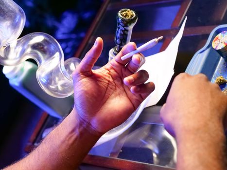 Photo of Person Holding Joint Made of Weed