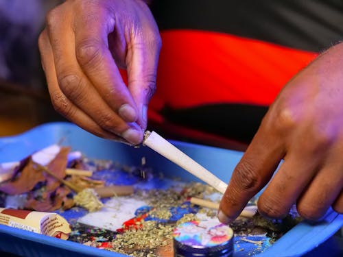 Close-Up Photo of Filling Weed on Rolling Paper